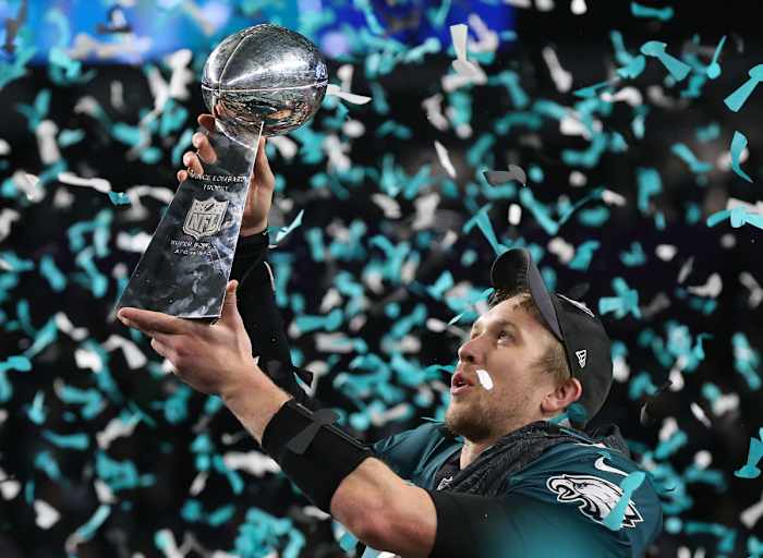 Feb 4, 2018; Minneapolis, MN, USA; Eagles quarterback Nick Foles (9) hoist the Vince Lombardi Trophy after a victory against the Patriots in Super Bowl LII at U.S. Bank Stadium.